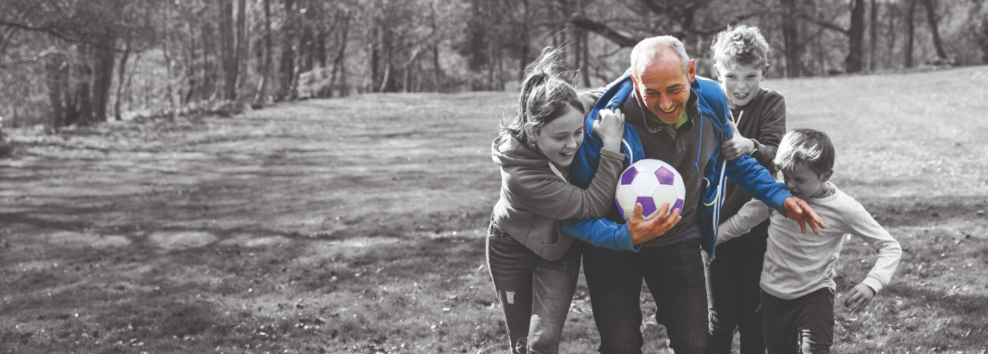 older-man-playing-football-with-grandchildren